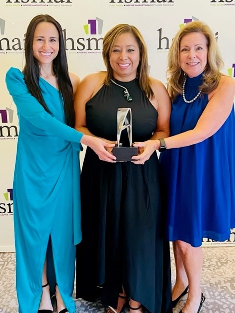 Ivonne, Camila and JoNell pose with the 2022 Sliver Adrian Award 